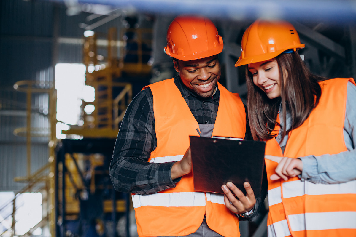 Two people reviewing paperwork on a clipboard